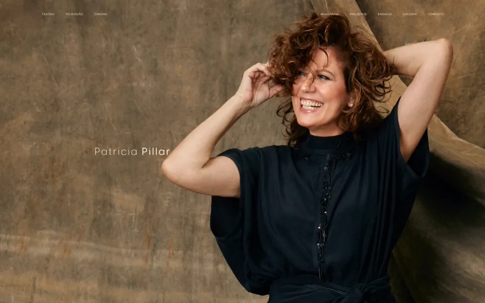 Patricia Pillar home page: a warm portrait of the actress laughing with her hand in her curly hair.